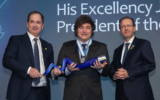 President of Argentina Javier Milei poses holding the Genesis Prize with Stan Polovets and Israeli President Isaac Herzog during the Genesis Prize ceremony at The Museum of Tolerance on June 12, 2025 in Jerusalem, Israel. (Lior Mizrahi/Getty Images for Genesis Prize Foundation via JTA)
